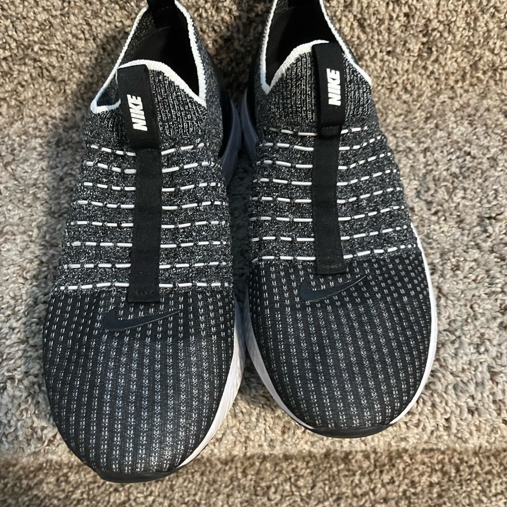 Nike women’s black and white slips on